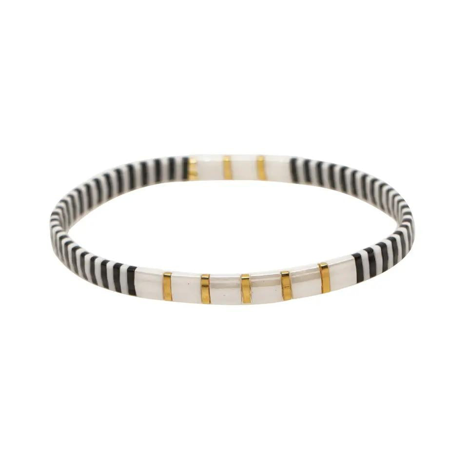 Inspired by the simplicity of Bali. This stunning stretch beaded bracelet is made from the finest tila beads.  Set in a sophisticated simple design of black and pearl and gold.  Tila glass bead stretch bracelet