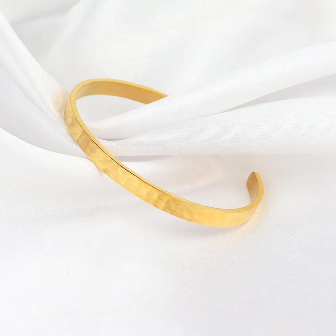 Get ready to turn heads with our Monaco bracelet! This bold and stylish piece features a high-polish and textured band design that's sure to make a statement. The hammered cuff bangle adds a touch of edgy elegance