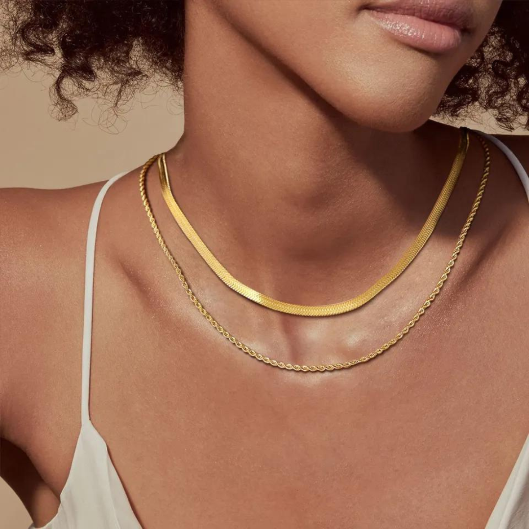 Featuring a delicate double stack of snake chain and twisted chain, this necklace adds a touch of chic sophistication to any outfi