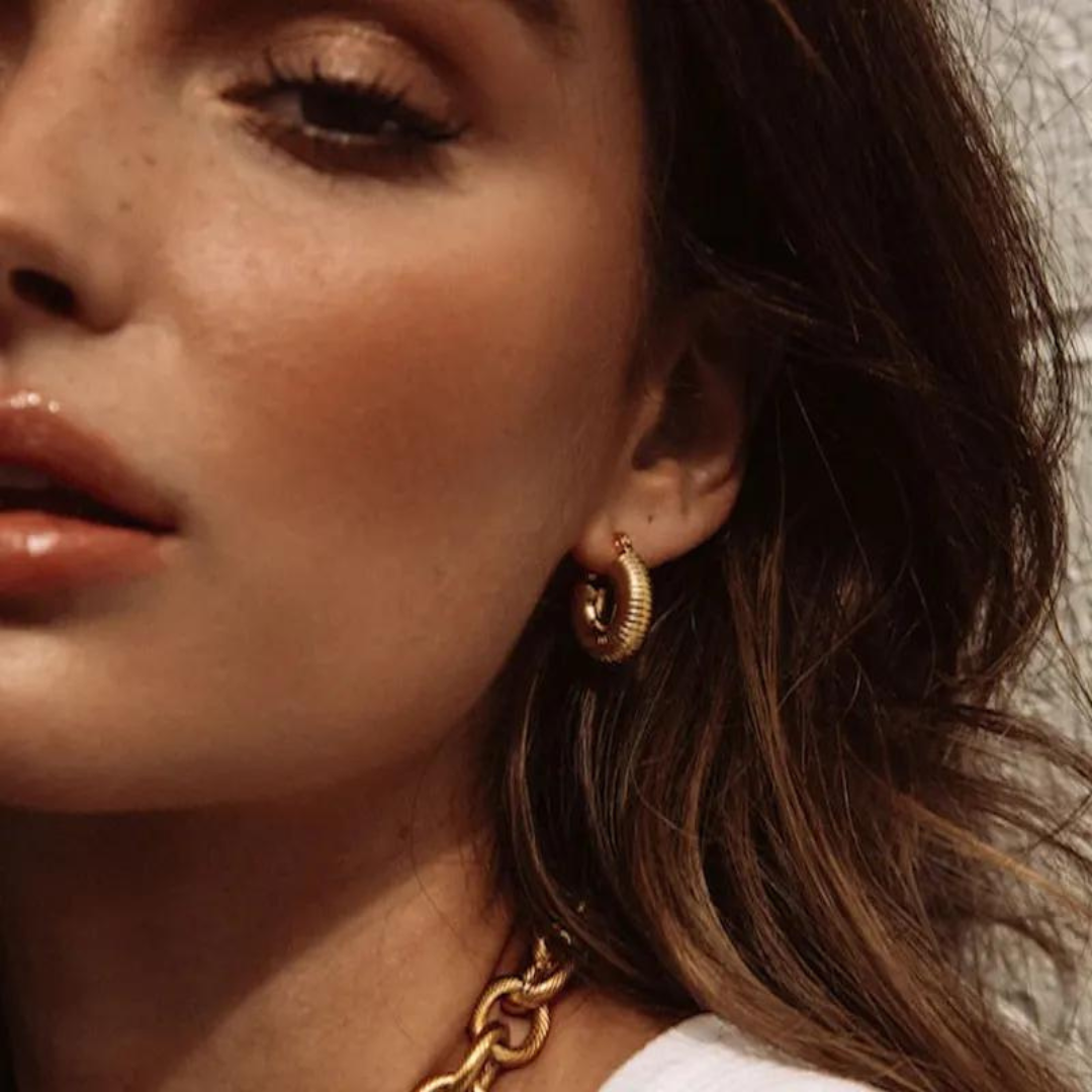 Exquisite "Clio" Gold Croissant Earrings, showcasing a trendy and elegant design in lustrous gold. Elevate your style with these sleek and minimalist earrings, perfect for adding sophistication and charm to any outfit