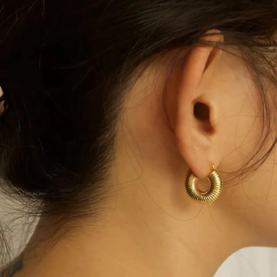 Exquisite "Clio" Gold Croissant Earrings, showcasing a trendy and elegant design in lustrous gold. Elevate your style with these sleek and minimalist earrings, perfect for adding sophistication and charm to any outfit