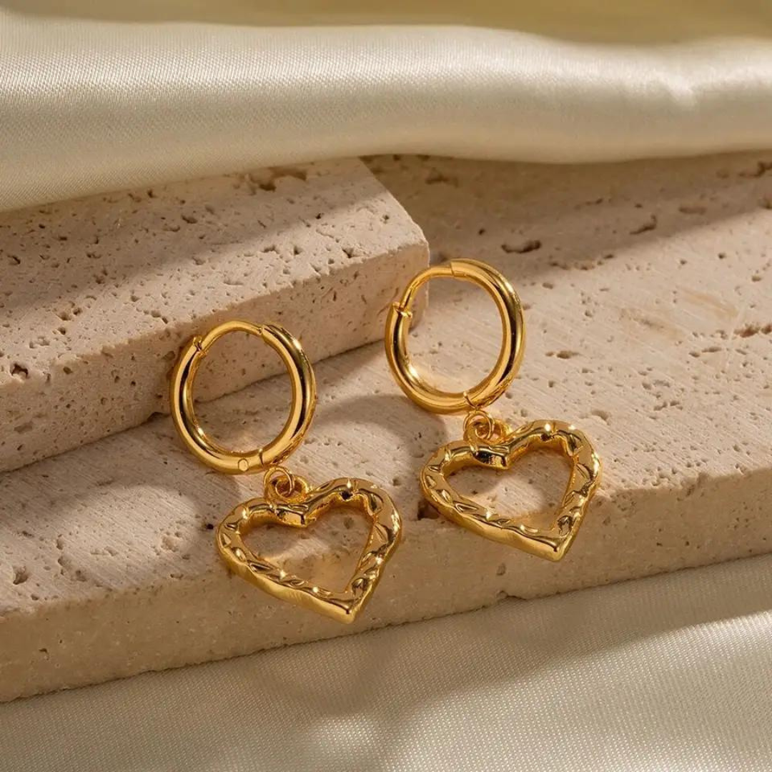 Crafted with attention to detail, these exquisite earrings feature hammered heart charms that symbolize eternal love and beauty. The minimalist design adds a touch of sophistication, while the durable stainless steel construction ensures long-lasting wear.