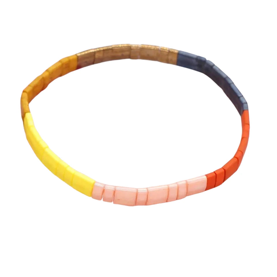 Inspired by the island of Barbados. This stunning stretch beaded bracelet is made from the finest tila beads. Fun and vibrant in pink, yellow, amber, burnt orange, and dark purples.. Tila glass bead stretch bracelet