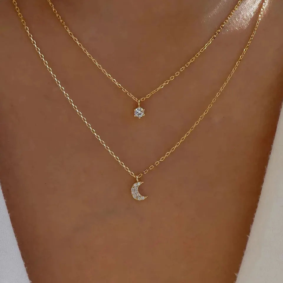 picture of a lady wearing the double gold chain with a sun and moon pendant