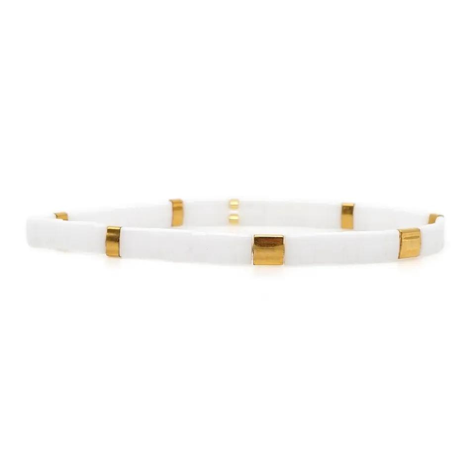 Stunning beaded stretch bracelet made from tiny square glass tila beads in white and gold. Tila glass bead stretch bracelet