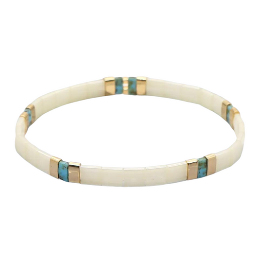 Inspired by the lovely beach of Ko Samui. This stunning stretch beaded bracelet is made from the finest tila beads which shine in pearls, aqua and gold