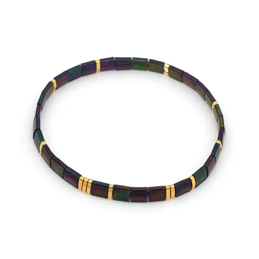 A stylish and sophisticated bracelet inspired by the rugged beauty of the volcanic island, made with lightweight and stretchable materials. Tila glass bead stretch band