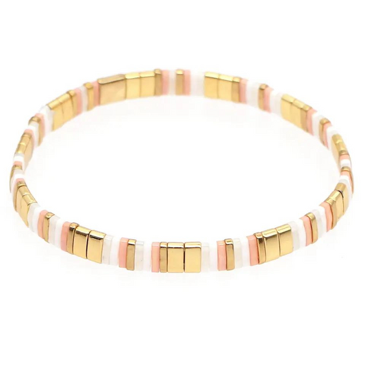 Inspired by the beaches of Zanzibar. This stunning stretch beaded bracelet is made from the finest tila beads which shine in pinks, pearls and gold. Tila glass bead stretch band